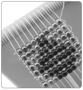 Seven rows of beads on a loom